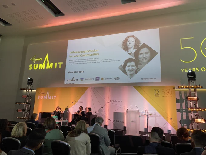 An image of a group of people talking on stage at the Solace Summit 2024.