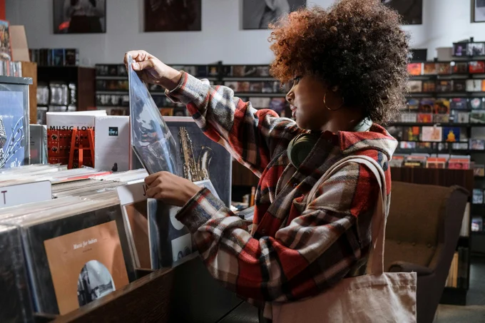 A young woman browses the racks at a record store