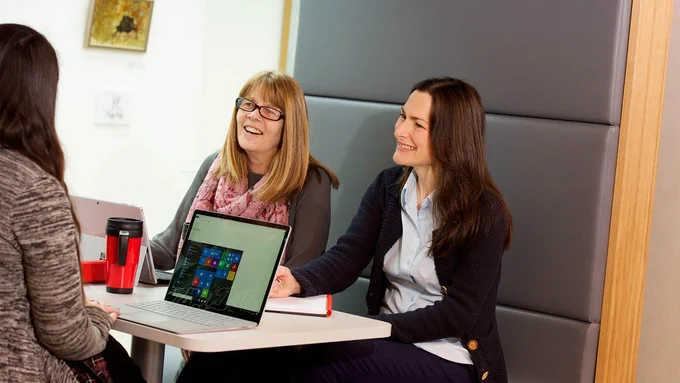 Image of people sitting at a table chatting