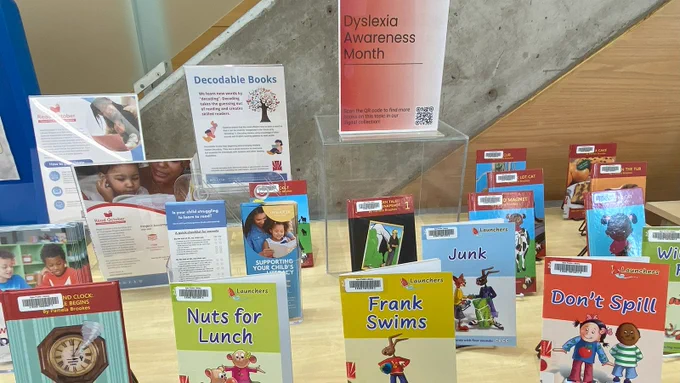 A table at Main Branch with a display of decodable books for children. 