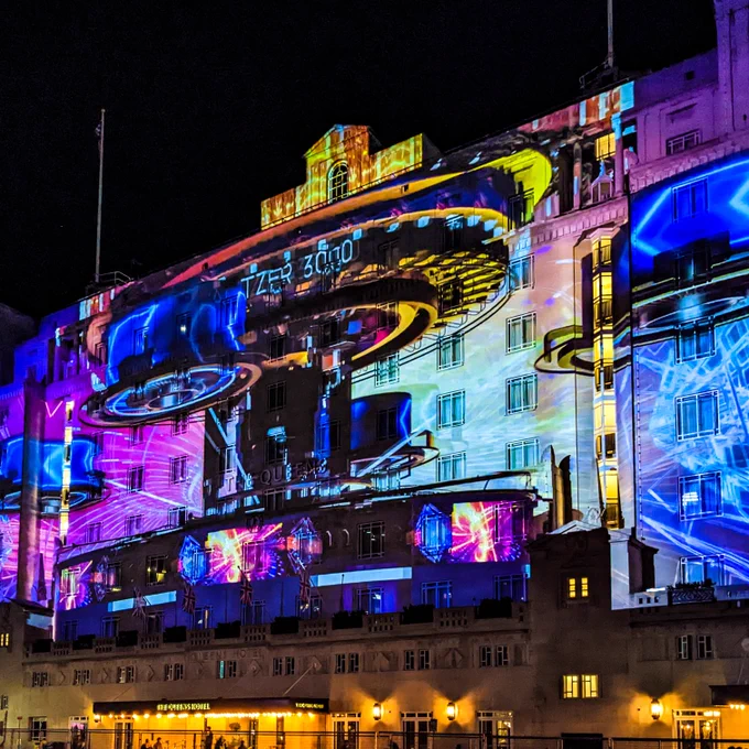 Light art projection of a theme park ride onto The Queens Hotel, Leeds. 