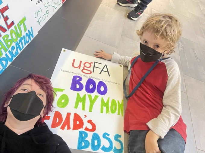 Photograph of a picket sign that says boo to my mom and dad‘s boss
