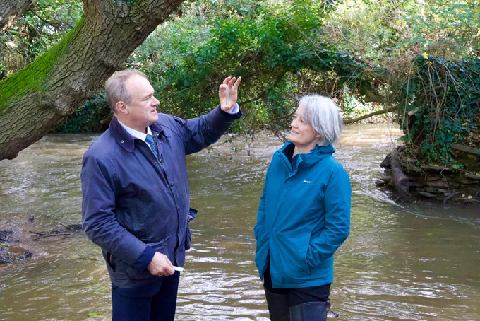 Ed Davey and Claire Young testing the water quality in the river Frome.