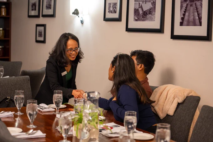 Arlene Fajutrao Dosen meeting students at the Harvest Dinner event including spiritual