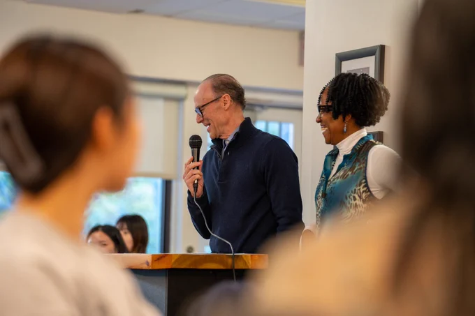 Spiritual care leader, Andy, and ecumenical chaplain, Marlice, sharing remarks at the Harvest Dinner event