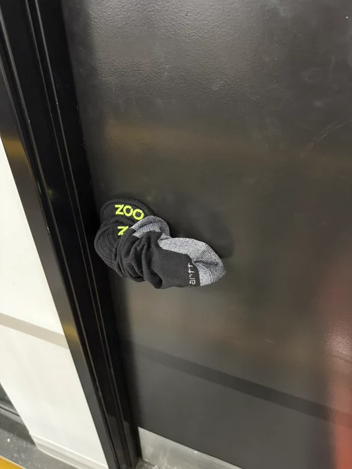 Two socks on a doorknob, emblazoned with a Zoo logo.