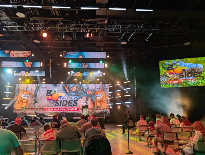 Stage with lights and signs for BSides Orlando 