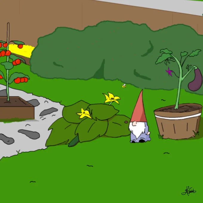 A small garden gnome statue sits in a lovely garden with a zucchini plant, an eggplant, and tomato plant. There is a wooden fence and a large bush. The gnome has a red hat, light-blue shirt, and big white beard.