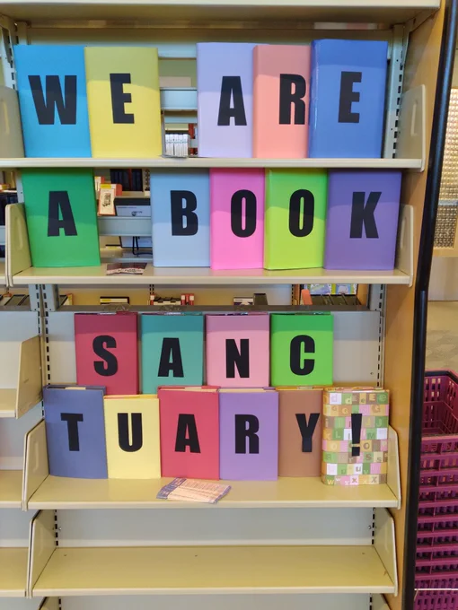 wrapped library books that spell out "WE ARE A BOOK SANCTUARY" 