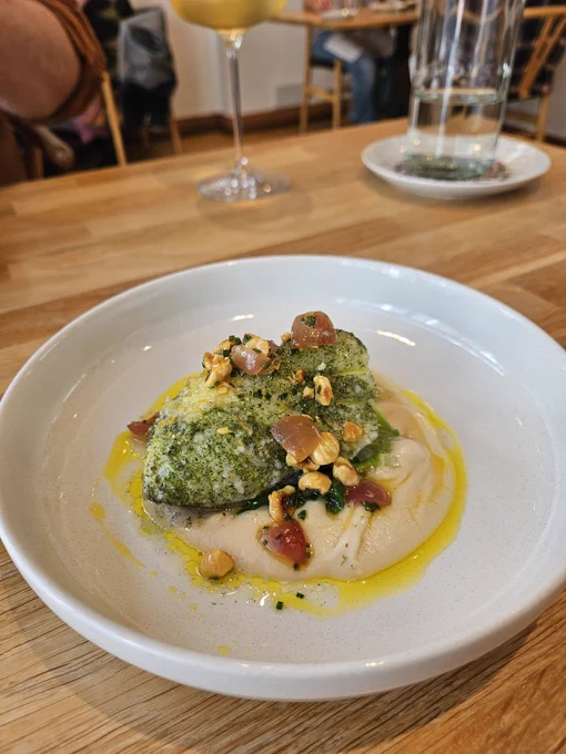 A plate with cod, buttebeans and hazelnuts