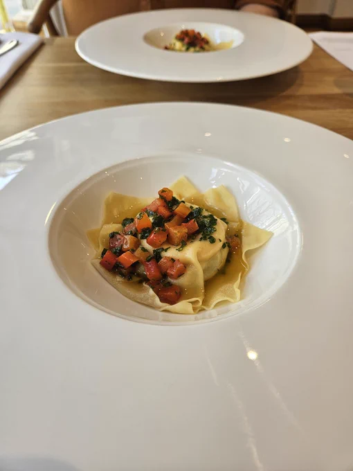 A plate with a raviolo on it