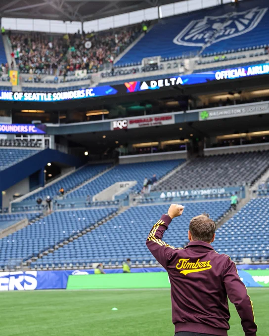 Phil Neville greets the traveling support