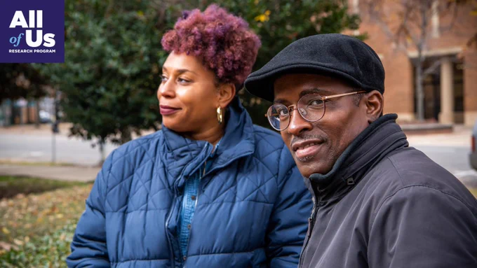 All of Us Research Program photo of a man and woman standing outside in a park, dressed for fall.