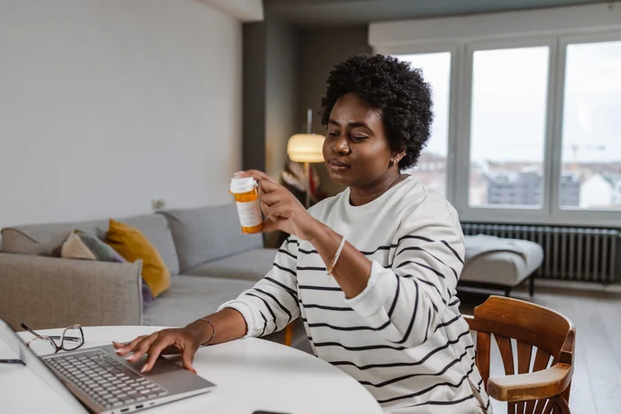 Young woman reading about the medicine online