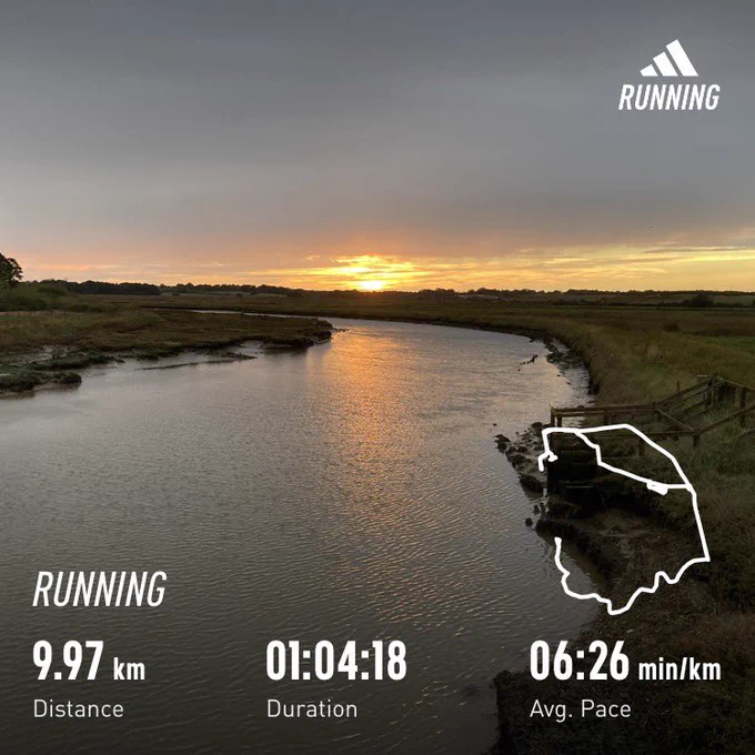 Sunset over a river; running stats superimposed (9.97km, 1:04:18)