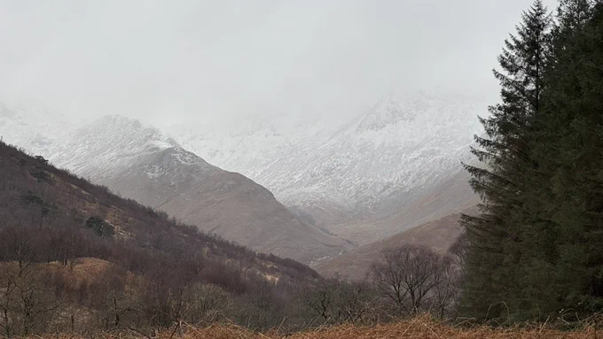Mist and snow on mountains of Glen Etitive
