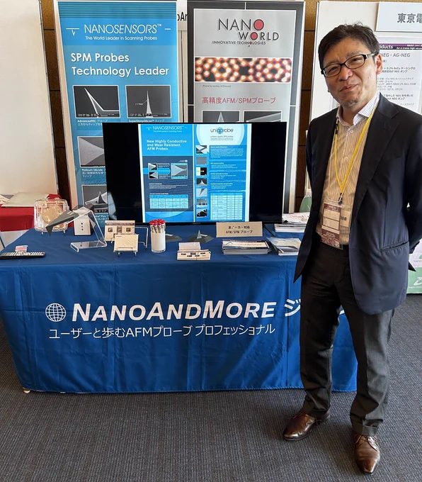 NanoAndMore Japan CEO Nobuhiro Saito in front of the NanoAndMore Japan AFM probes booth at the 10th International Symposium on Surface Science in Kita-kyushu, Fukuoka Japan