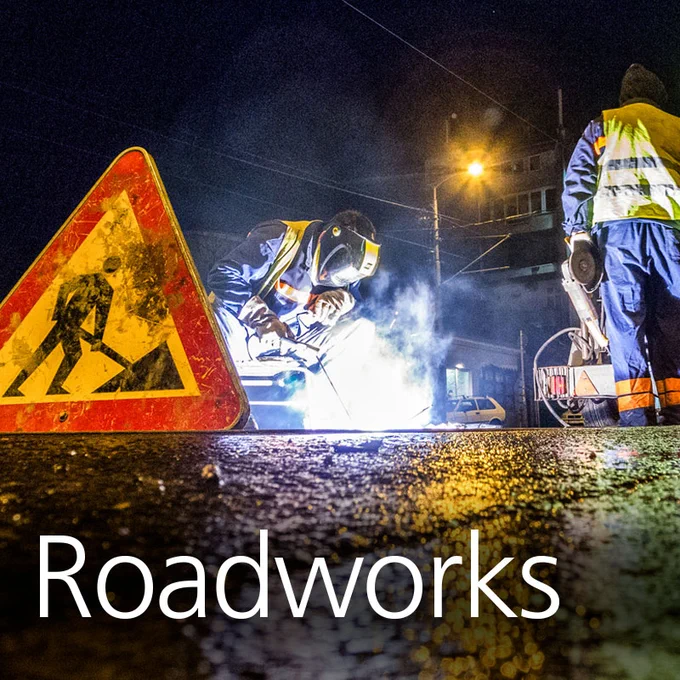 Workers completing roadworks with text overlaid that reads " roadworks"