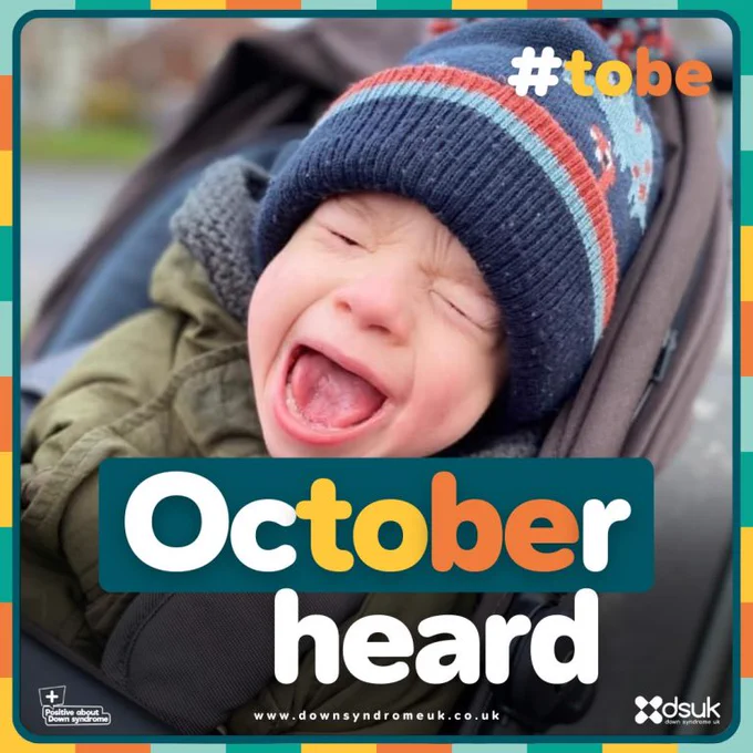 October heard. #tobe www.downsyndrome.co.uk. Image of toddler in pram shouting.