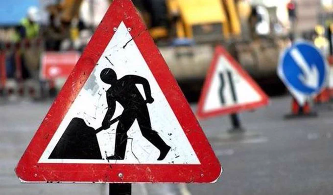 A photo of three roadworks signs.