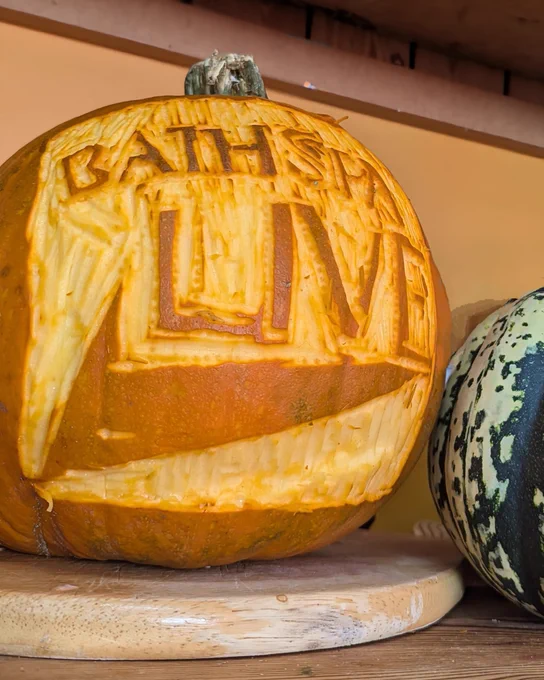 A pumpkin with the Bath Spa Live logo carved in it.