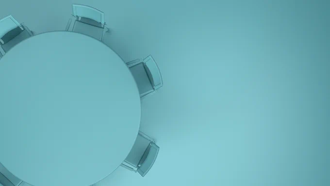 A round table with chairs around it.