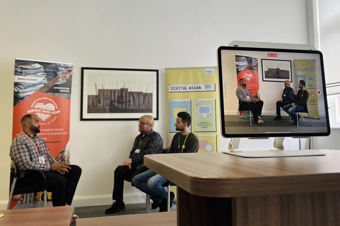 Three people sat on chairs talking