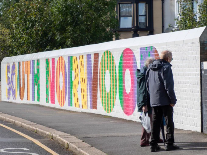 Two adults looking at the new mural on Goathouse Bridge