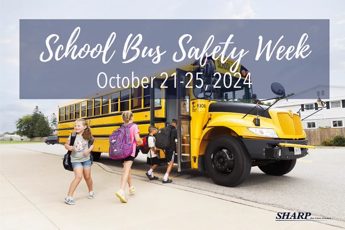 An image of students boarding a school bus with their backpacks on and smiling. There is a heading that states "School Bus Safety Week - October 21-25, 2024".
