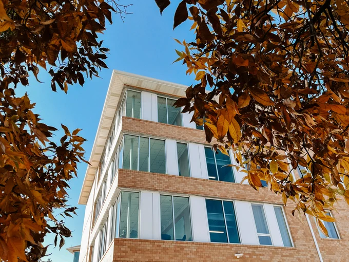 Orange leaves frame a building on East Campus