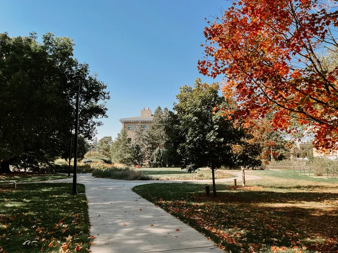 The Arboretum on East Campus begins to turn orange with the Visitor's Center in the distance