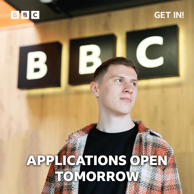 A BBC colleague stood in front of a large BBC logo.
Text reads: Applications open tomorrow.