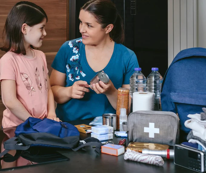 An adult and child packing an emergency kit