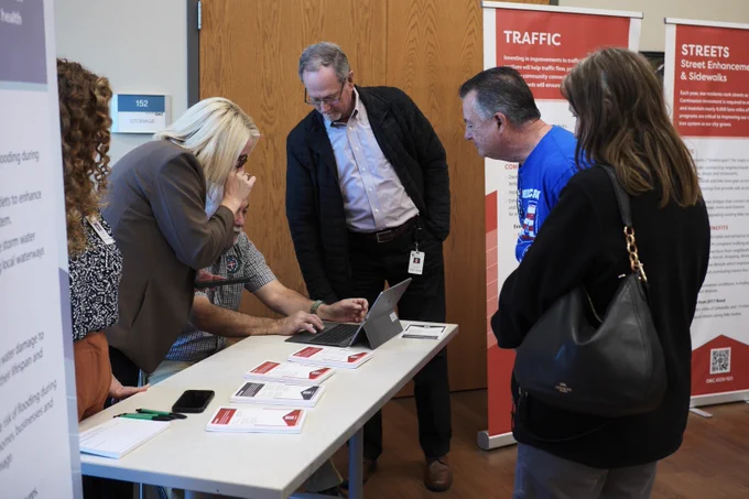group of people looking at a laptop 