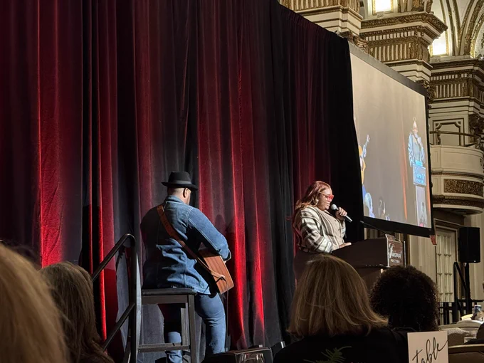 Miranda Rae performing at event with guitarist