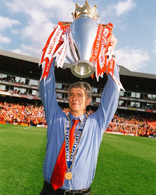 Arsene Wenger lifts the Premier League trophy.