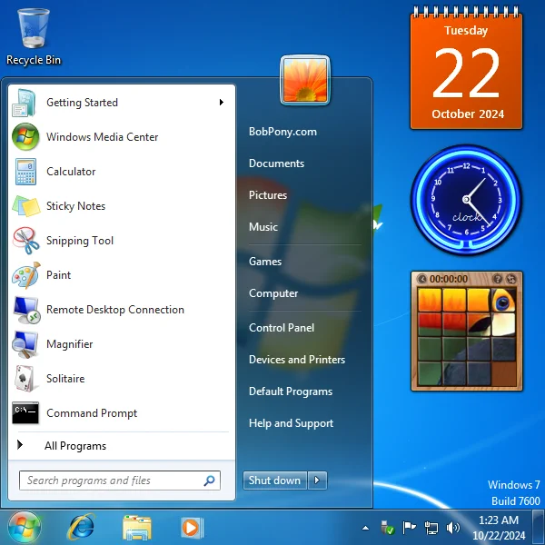 Screenshot of the Windows 7 desktop, showing the start menu and the few desktop gadgets (calendar, clock, and picture puzzle) at the right side.
