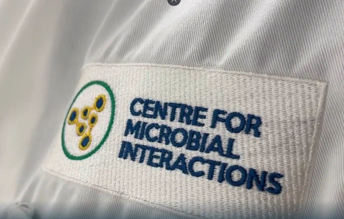 A close up of the CMI logo printed on a lab coat