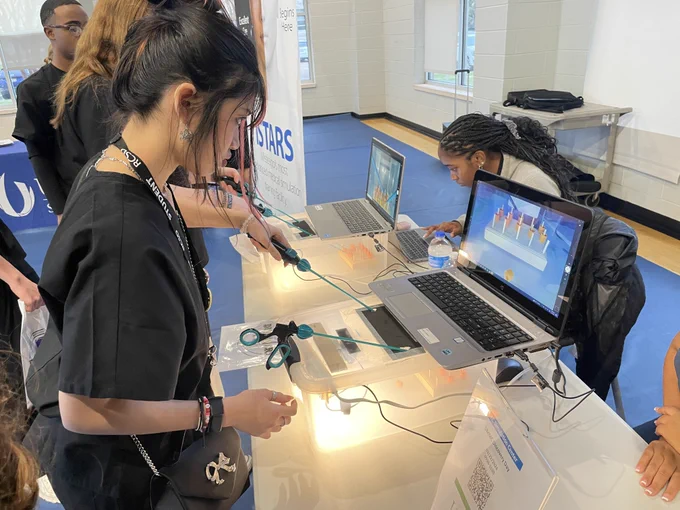 Students solve a problem using a simulator.