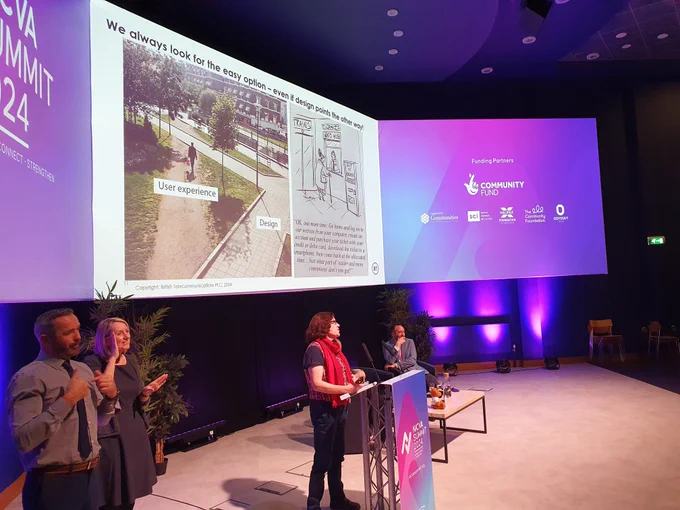 Photo of Dr Nicola Millard speaking from a podium