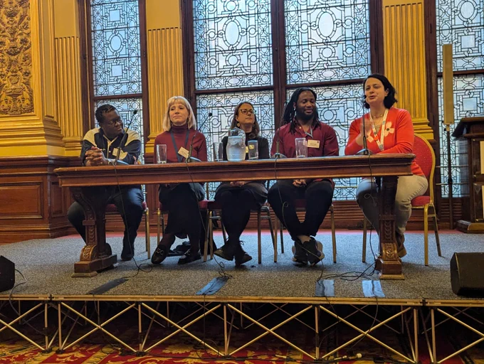 A panel of Scottish Refugee Council staff and volunteers talk to members