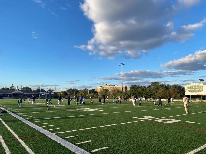 A large group of local children receive instruction from law enforcement officers and college lacrosse players. 