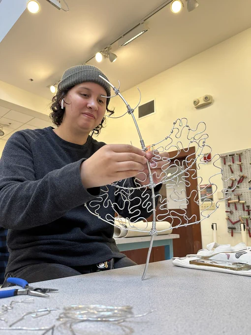 Student working on a wire sculpture.