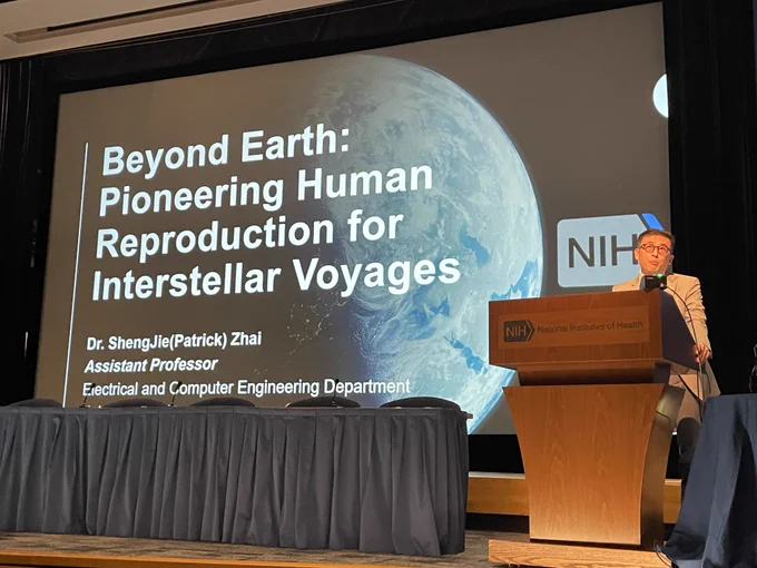 A photo of Shengjie Zhai speaking at an NIH event in front of a slide with a title that reads: Beyond Earth: Pioneering Human Reproduction for Interstellar Voyages