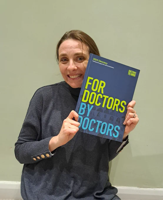 A photo of me holding the Doctors Training 2024 directory of courses