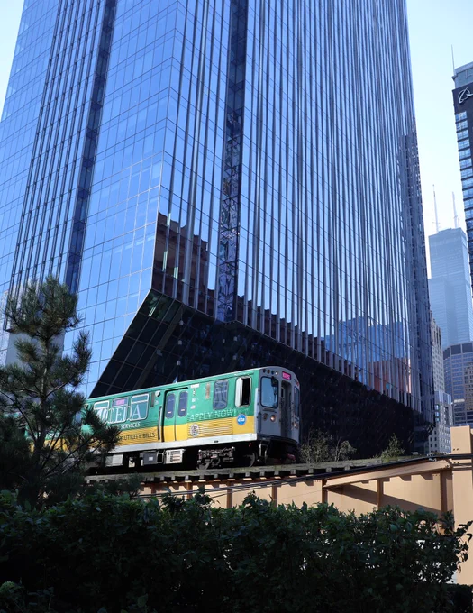 Train passes in front of building