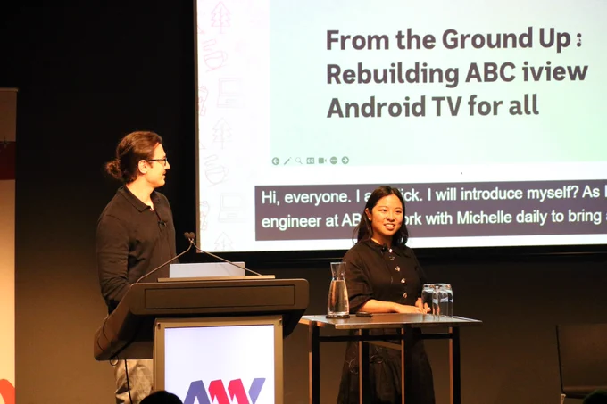 Michelle and Nick Stathakis speaking in front of a lectern. 