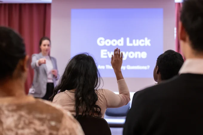 Image of a student asking questions during an open day.