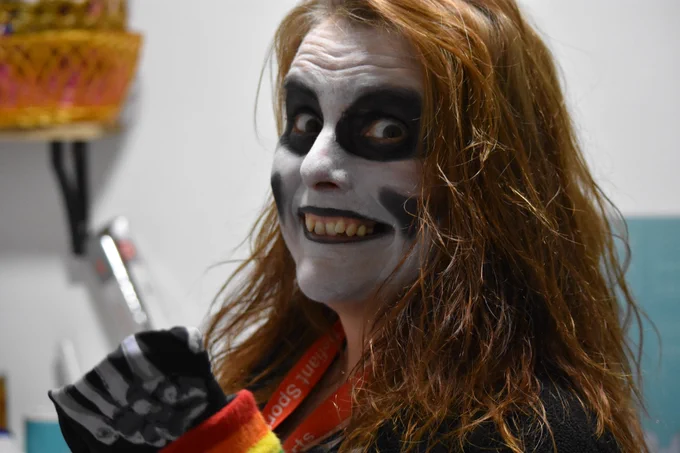 Loretta smiling creepily in a skeleton outfit.
