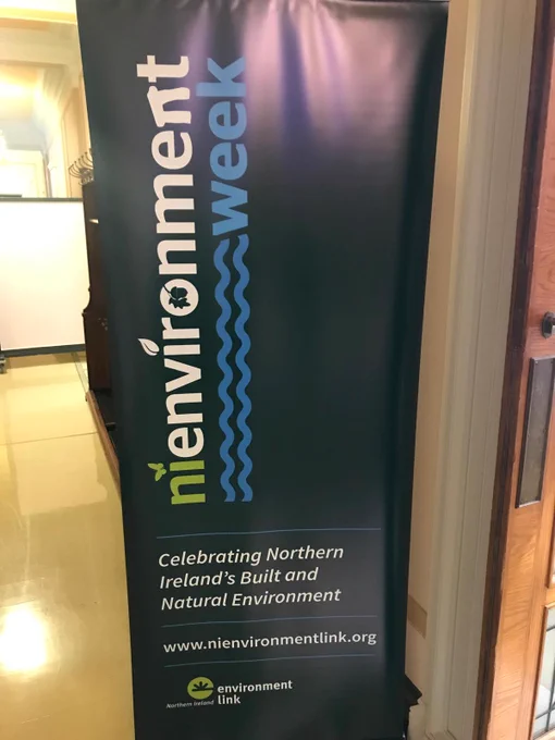 Photo of a black pop-up display with text "NI environment week. Celebrating Northern Ireland's Built and Natural Environment. www.nienvironmentlink.org". NIEL logo is at the bottom. 